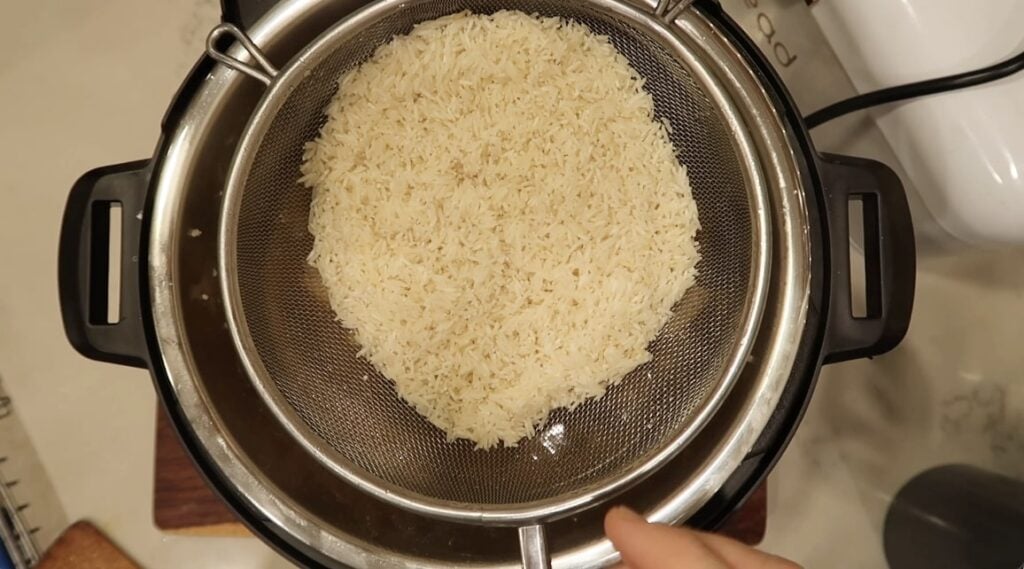 Adding rinsed basmati rice to pot